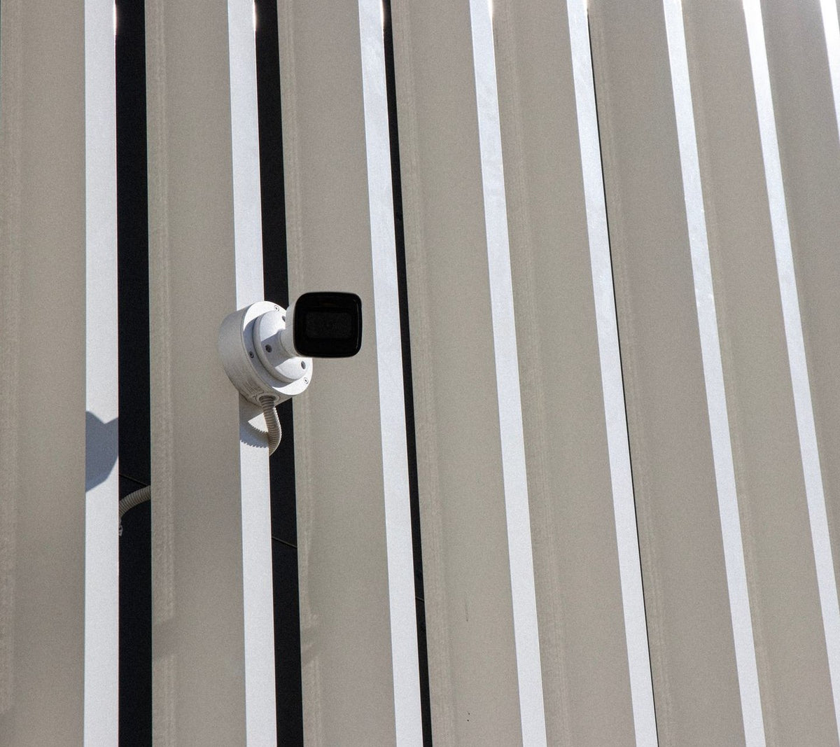 Security camera on a sculptural modern building facade